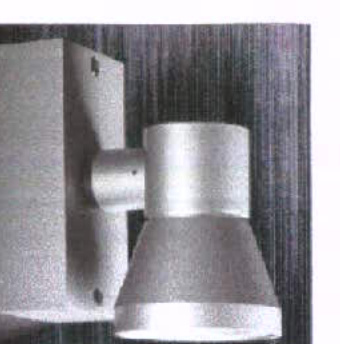A grainy close-up photograph of a silver, wall-mounted external light fixture.