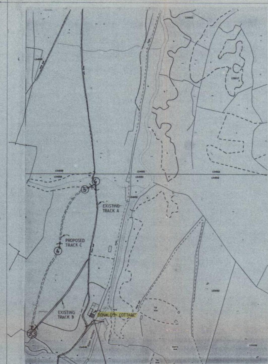 A site location map showing the position of Donald's Cottage relative to existing and proposed tracks, with grid references visible.