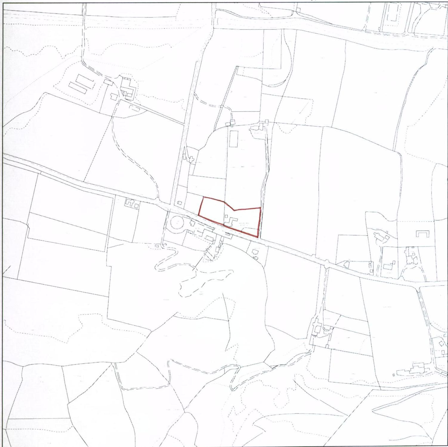 This image shows a site location plan with the application plot highlighted in red, surrounded by rural fields and existing buildings.