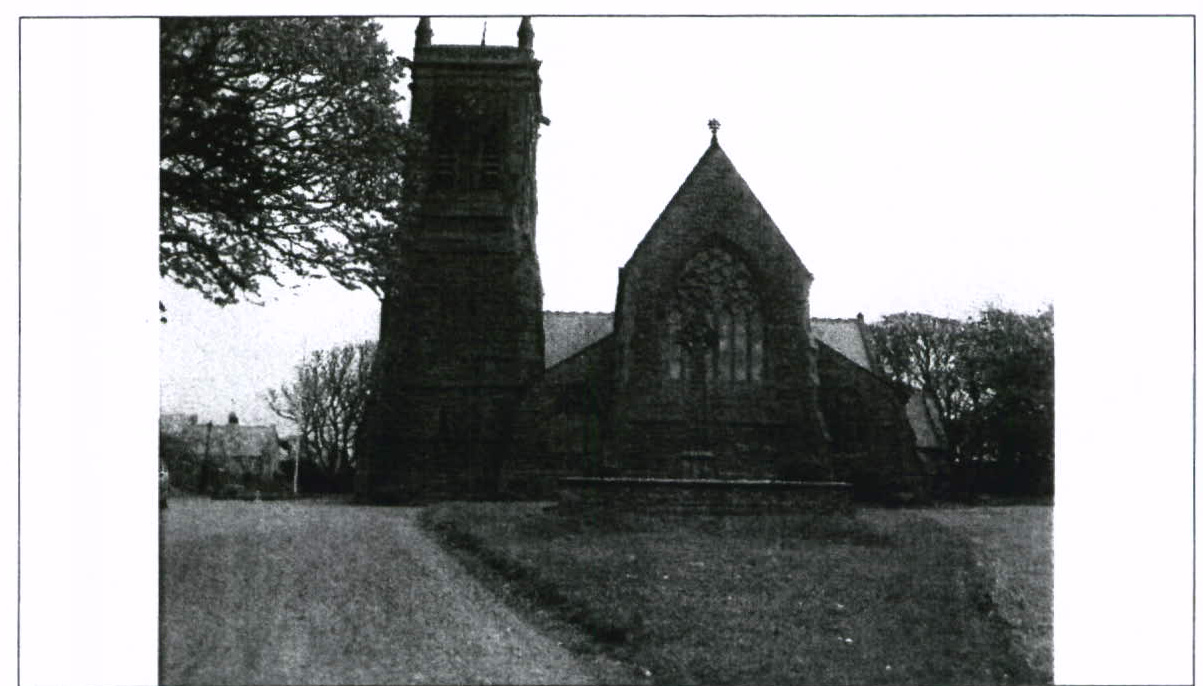 A grainy black and white photograph showing a stone church or chapel with a prominent tower and a large arched window.