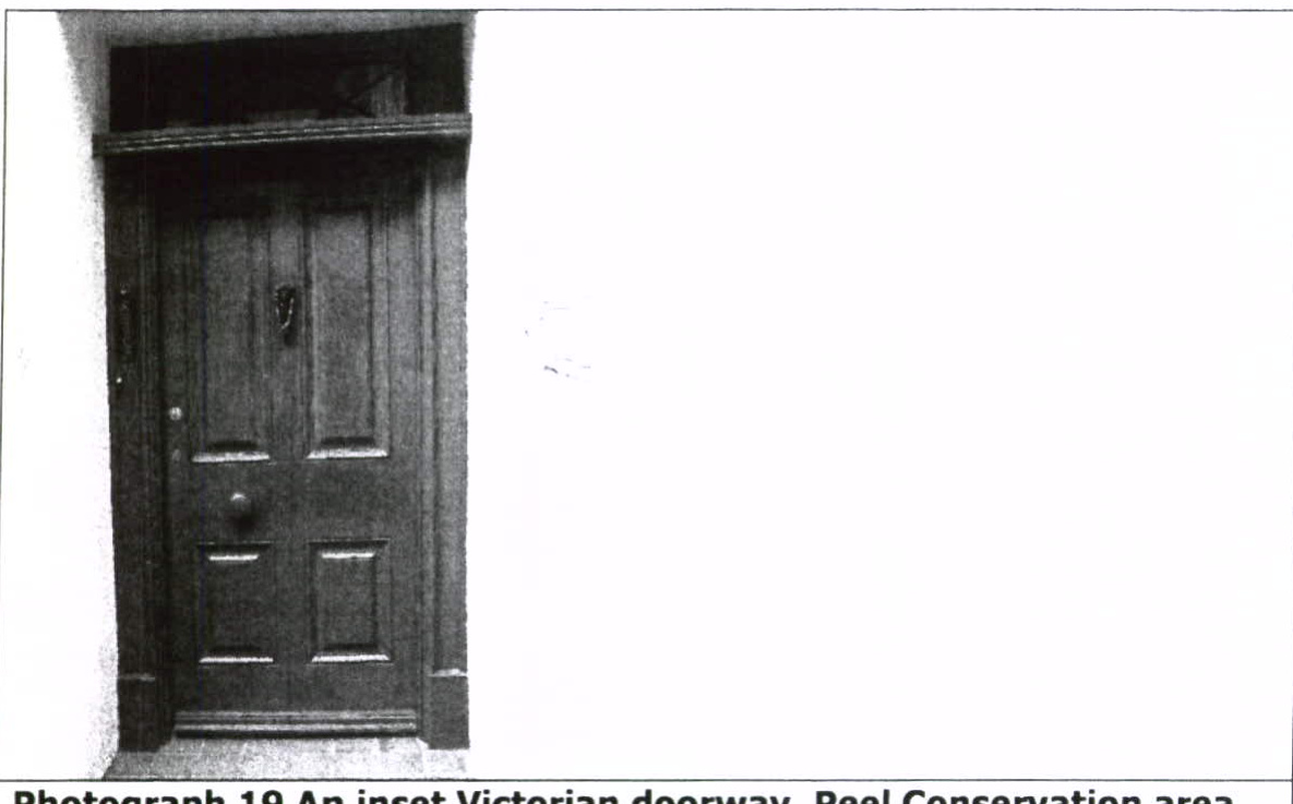 A black and white photograph showing an inset Victorian wooden doorway, labeled as Photograph 19 from the Peel Conservation area.