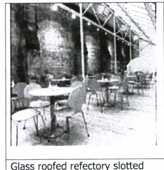 A grainy black and white photograph showing the interior of a large building with stone walls and a high pitched roof, furnished with tables and chairs, captioned as a glass roofed refectory.