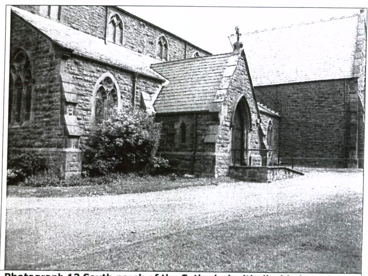 Black and white photograph showing the exterior of a stone church or cathedral, specifically focusing on a south porch with Gothic arched windows and a cross on the roof.
