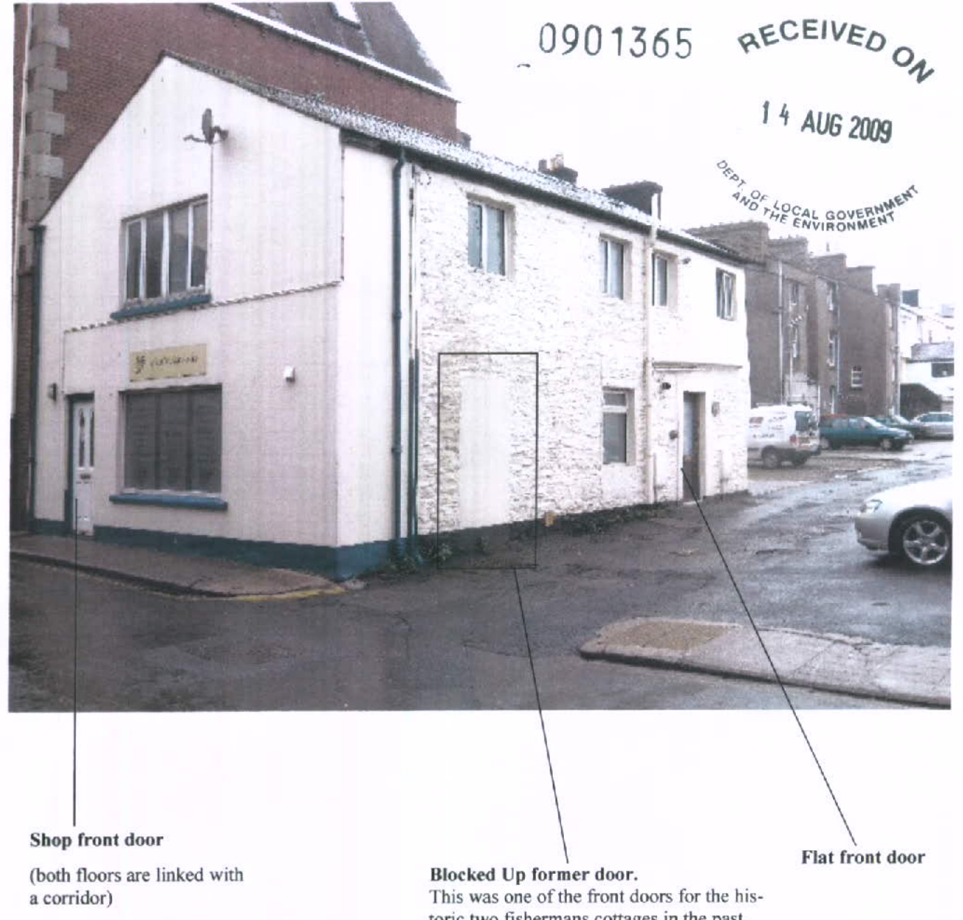 Annotated photograph of a corner building showing a former shop front and residential doors, with text indicating a blocked former door.