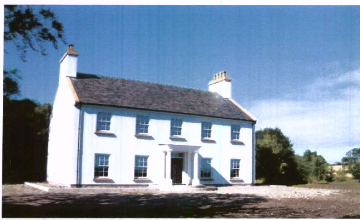 A photograph of a large white two-story detached house with a slate roof, likely the existing dwelling proposed for demolition.