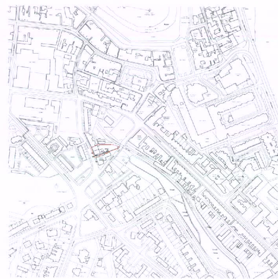 A black and white line drawing depicting a street layout with building footprints, featuring a specific plot highlighted by a red boundary line.