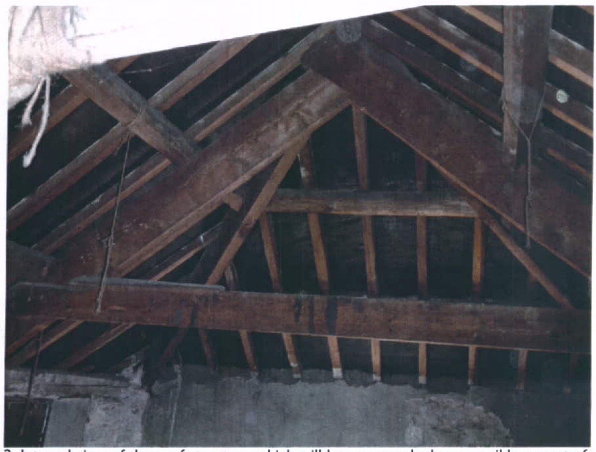 Interior photograph showing the exposed traditional timber roof structure with rafters and beams.