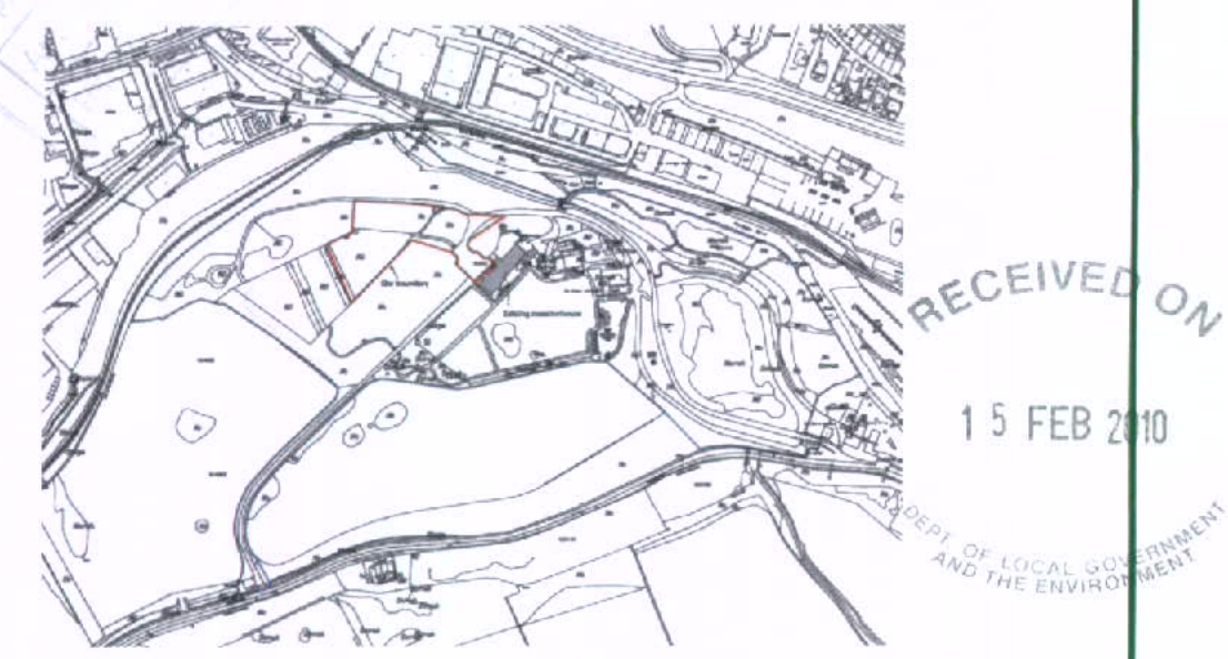 A site plan showing the proposed development area outlined in red, including access roads and parking spaces.