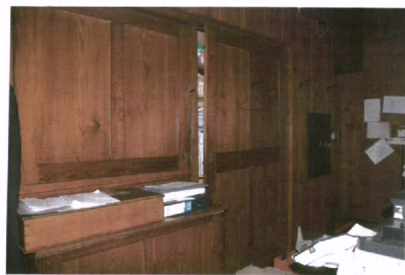 The image shows an interior room with extensive dark wood paneling and built-in wooden cabinetry, likely depicting the South Clergy Vestry mentioned in the application.