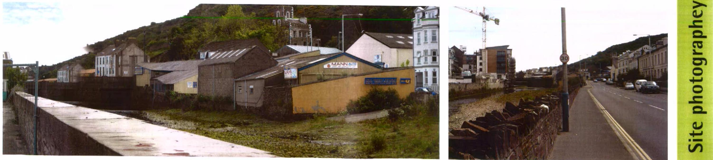 Panoramic site photograph showing existing industrial buildings along a canal and a road with traffic.