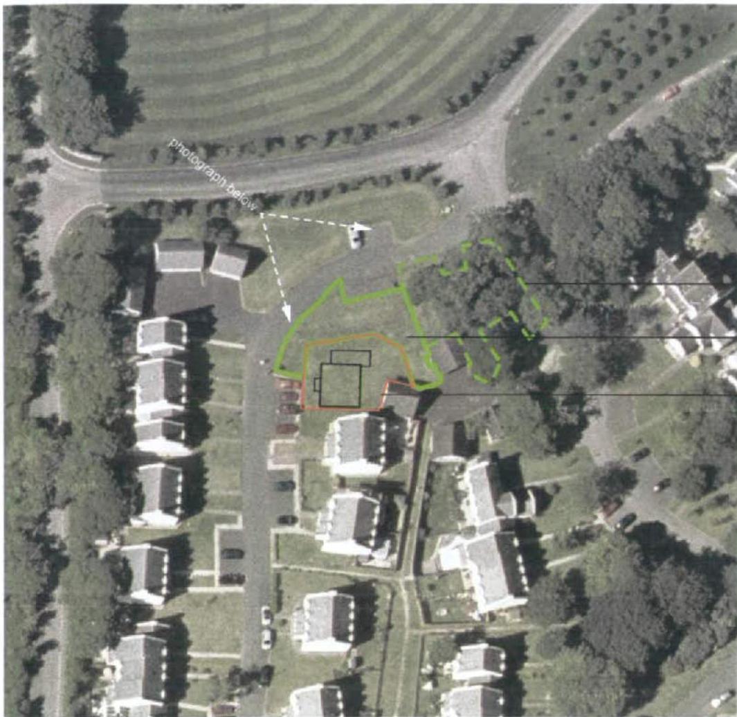 An aerial view of a residential area with colored boundary lines overlaid to indicate specific land parcels or development sites.