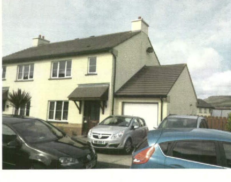A photograph showing the front elevation of a two-story semi-detached house with an attached garage and cars parked in the driveway.