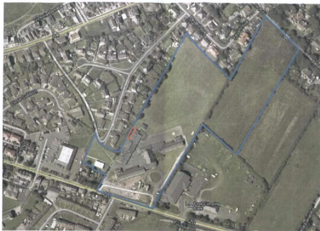An aerial site location map showing land parcels outlined in blue lines with a small red highlighted area near a building complex.
