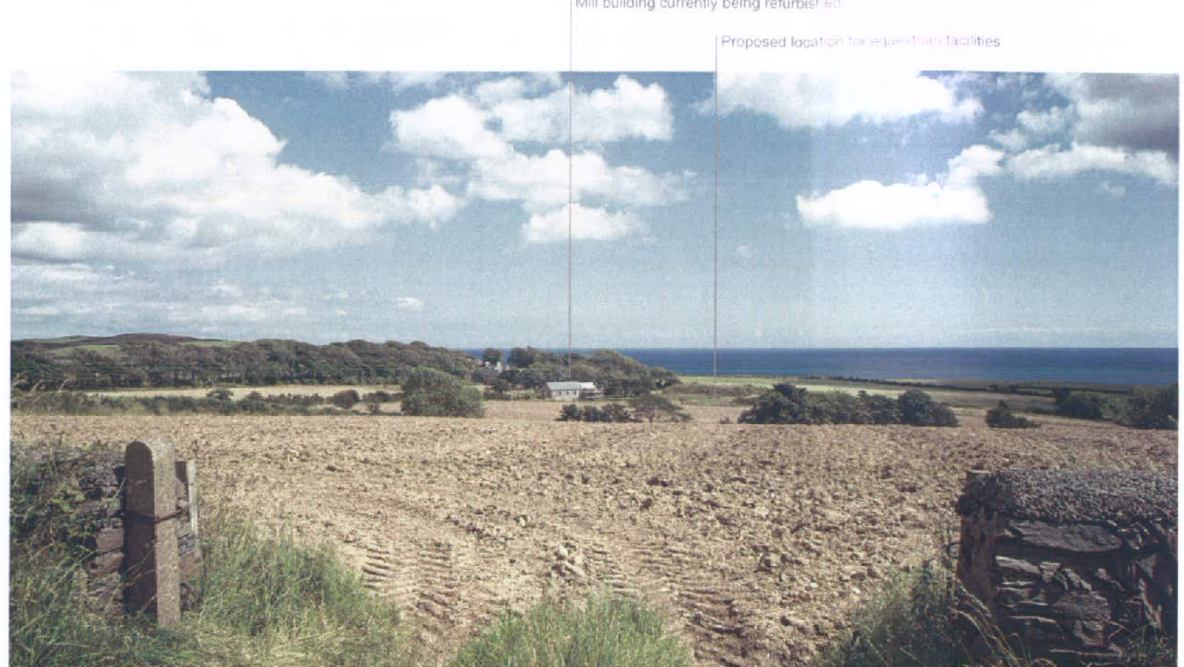 A photograph showing a ploughed agricultural field with stone walls in the foreground and a coastal view with the sea in the distance. Text overlays indicate the location of a mill building and the proposed site for e...