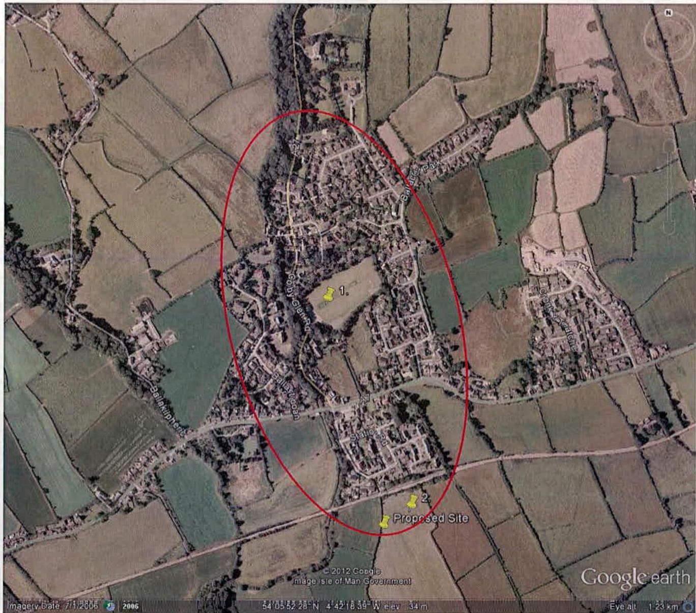 Aerial Google Earth view showing a proposed site location marked with a red boundary line within a rural village settlement.