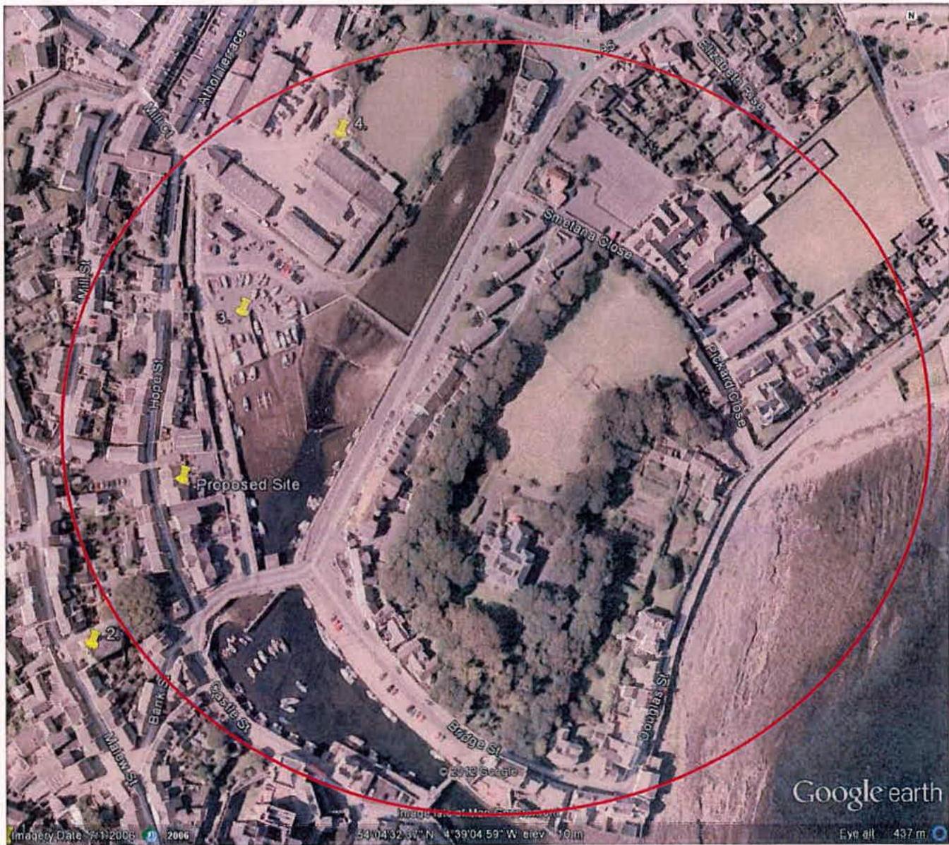An aerial Google Earth location map showing a proposed site marked with a yellow pin and a red search radius circle covering a coastal town area.