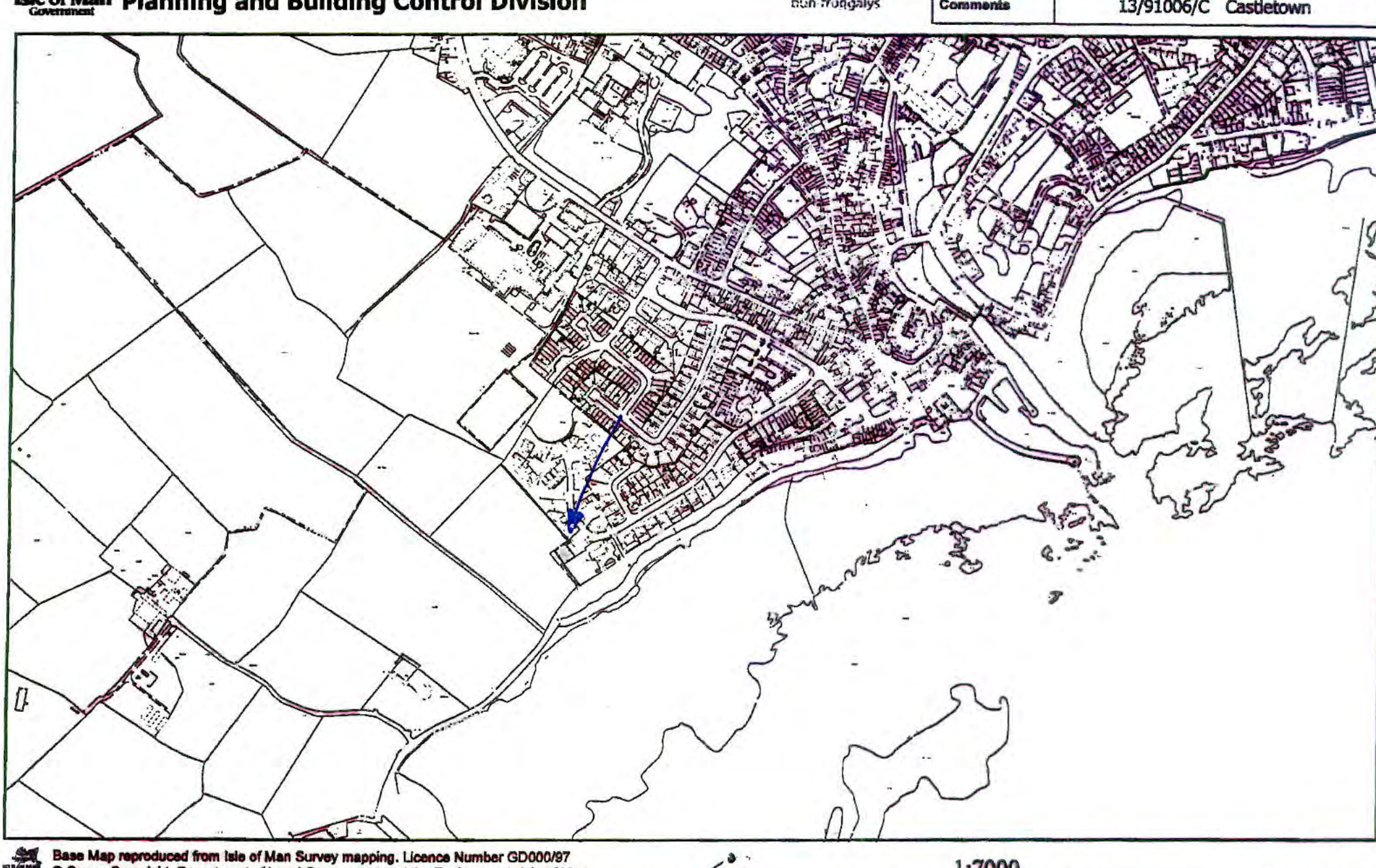 A black and white location map showing the site boundary marked with a blue arrow near the edge of a coastal town.