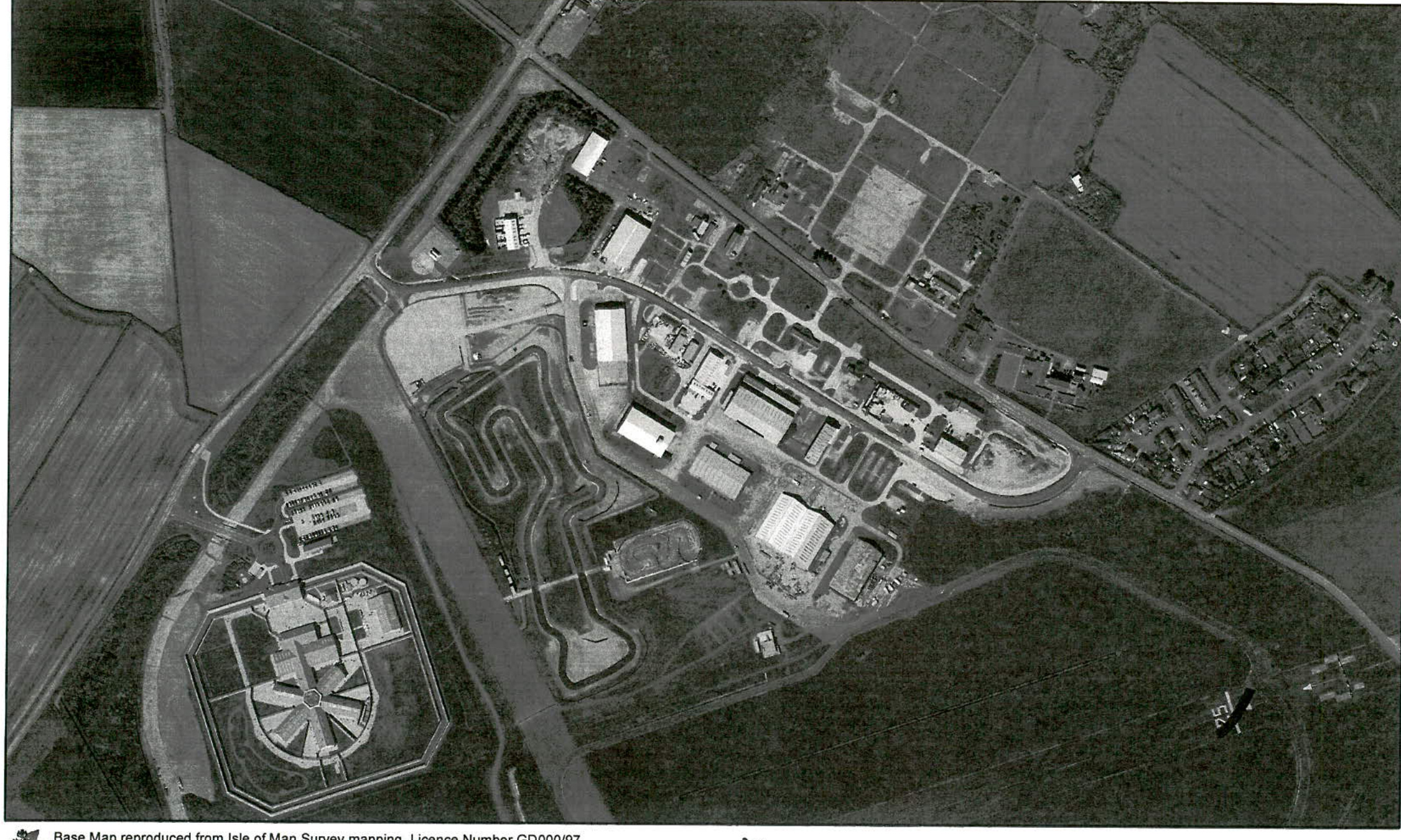 Black and white aerial base map showing a rural site with a circuit track, large industrial buildings, and surrounding agricultural fields.