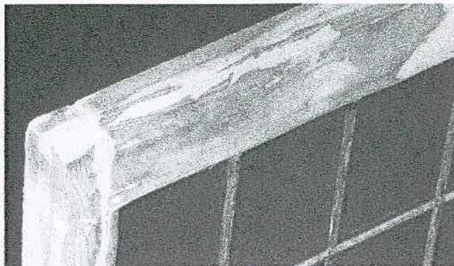 A grainy, close-up image showing the corner of a wooden window frame with glazing bars, likely a photo of the existing condition for repair works.