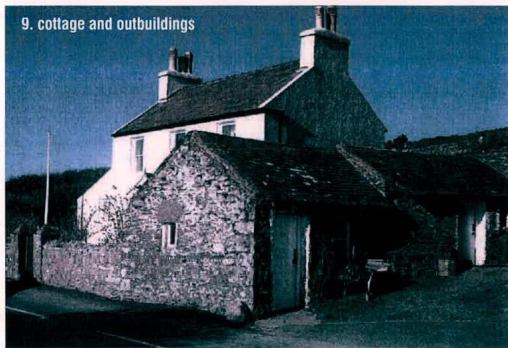 A photograph showing a stone cottage with attached outbuildings and a stone wall in the foreground.