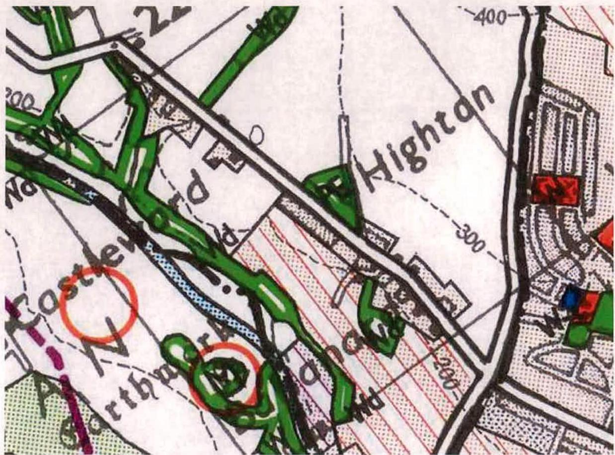 A cropped section of a topographical map showing roads, buildings, and vegetation with contour lines and handwritten annotations.