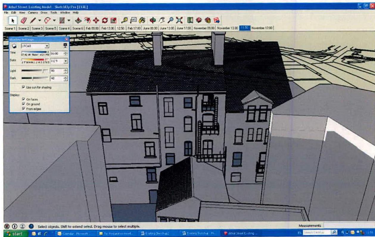 A screenshot of a SketchUp 3D model showing a street view of terraced buildings with chimneys and shop fronts.