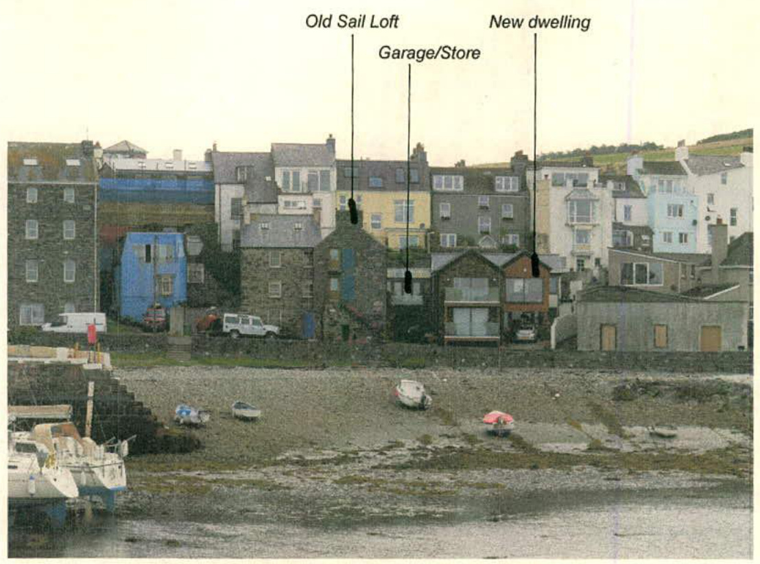 An annotated photograph showing a coastal hillside street scene with labels identifying an 'Old Sail Loft', 'Garage/Store', and a 'New dwelling'.
