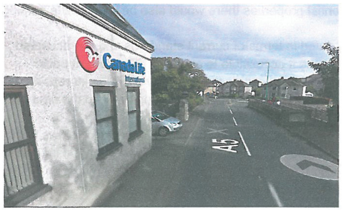 Exterior photograph of a white commercial building with a Canada Life sign located on a street corner.