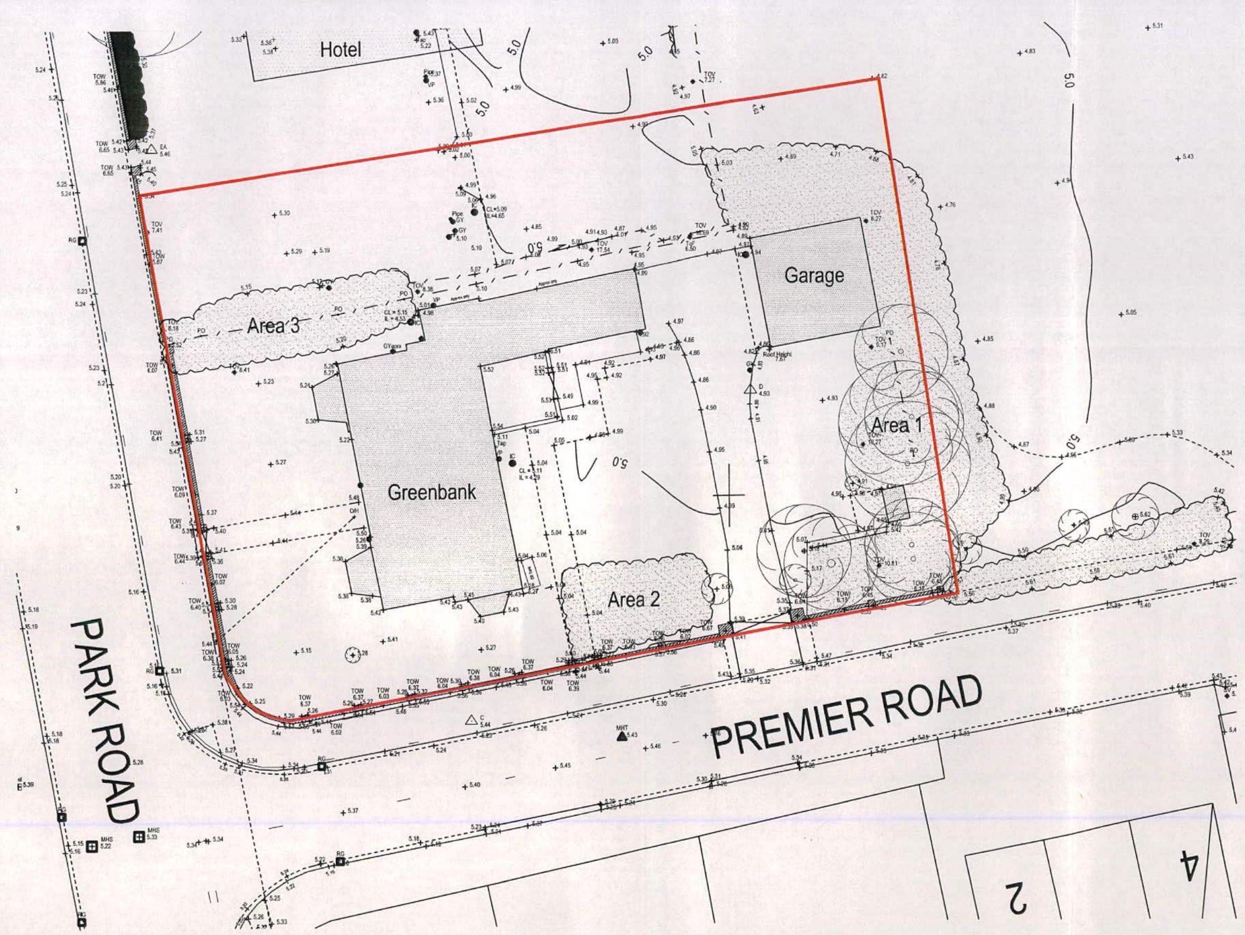 A technical site plan displaying the property boundary in red, existing structures like 'Greenbank' and a 'Garage', and surrounding roads including Premier Road.