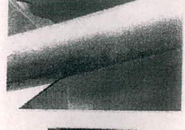 A grainy, low-resolution image showing a dark diagonal shape, likely a close-up of play equipment or a structural element.