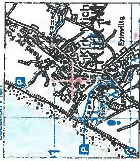 A black and white topographical map extract showing road networks, building footprints, and blue parking symbols.