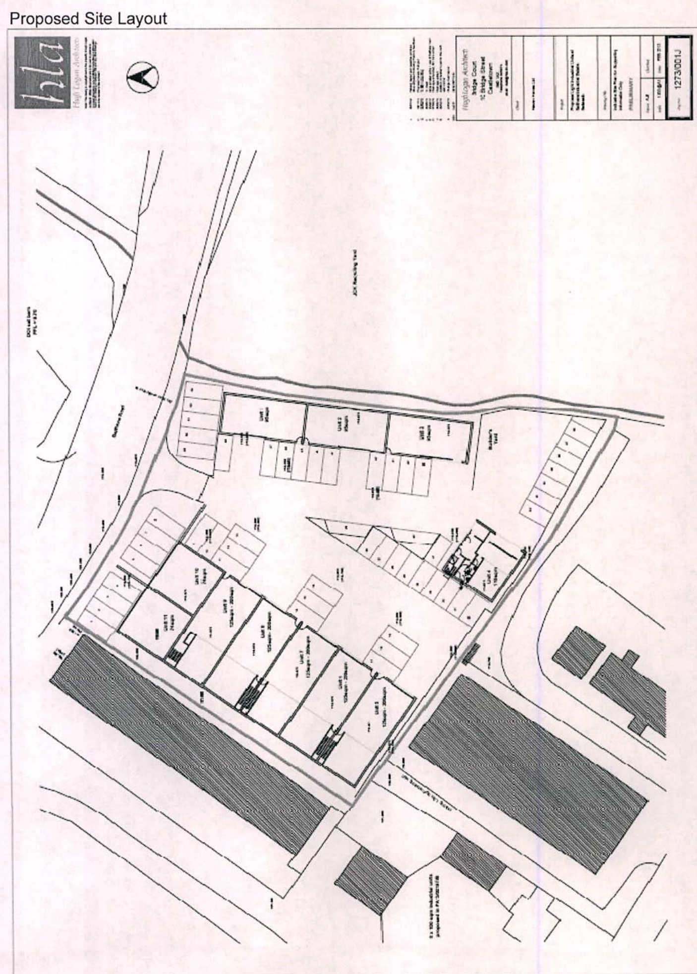 A black and white technical drawing titled 'Proposed Site Layout' showing parking bays, building outlines, and site boundaries with a north arrow.
