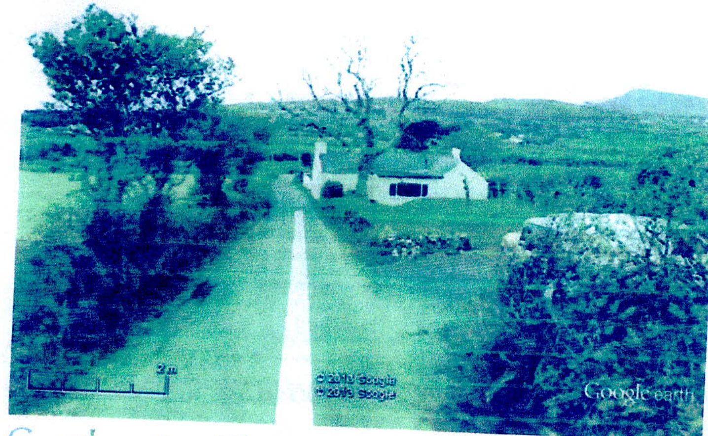 A low-resolution Google Earth screenshot showing a white dwelling situated next to a road in a rural, hilly landscape with stone walls.