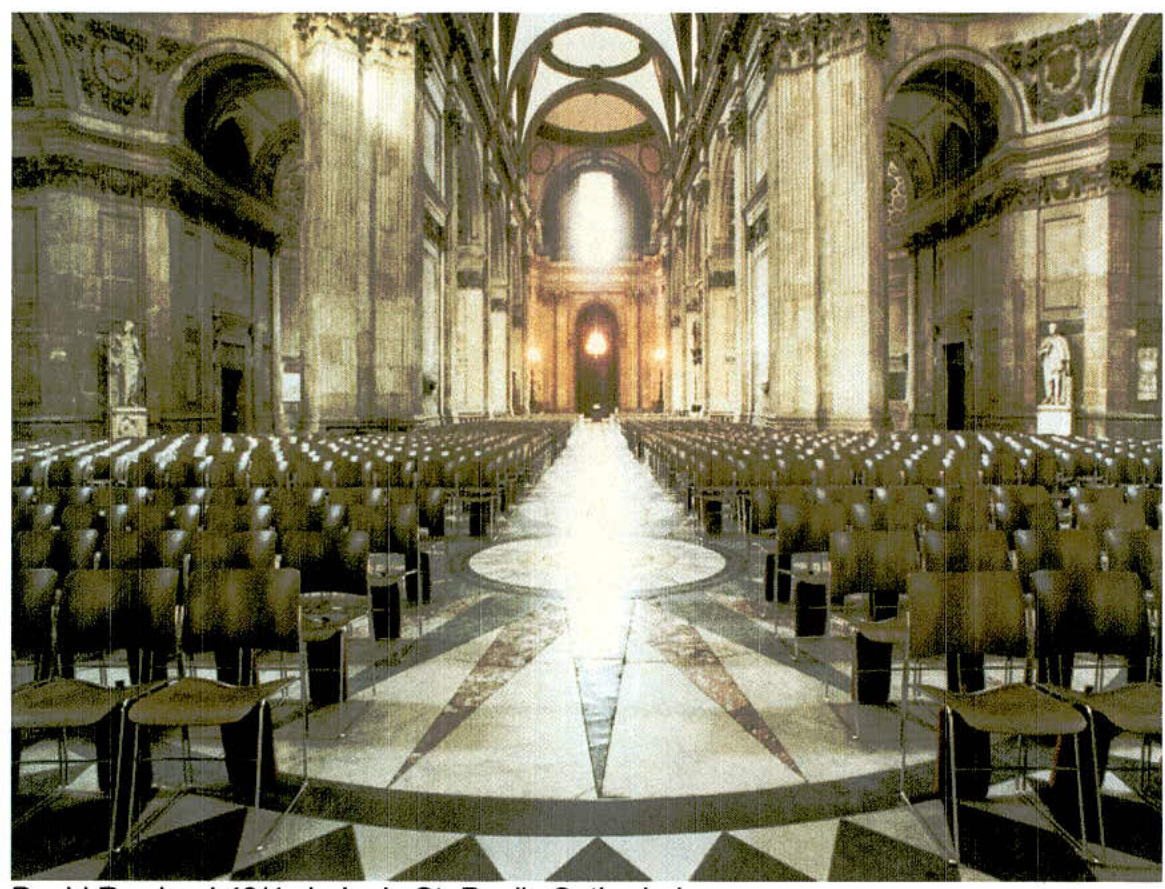 Interior view of a large ornate hall or church nave with rows of chairs arranged on a geometric floor, featuring high arches and columns.