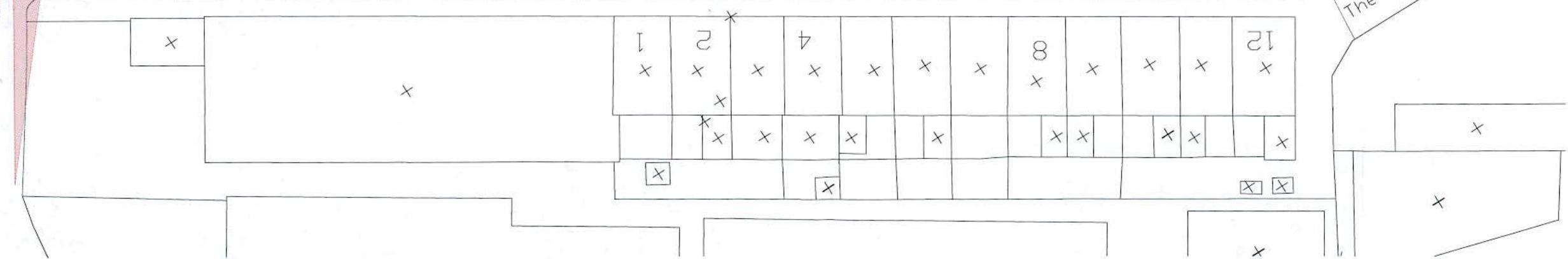 A black and white architectural site plan showing a layout of numbered plots, likely residential units, with boundary lines and tree markers.