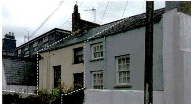 A photograph showing a row of terraced houses with a dashed white line outlining a specific section of the building, likely indicating a proposed extension or alteration.
