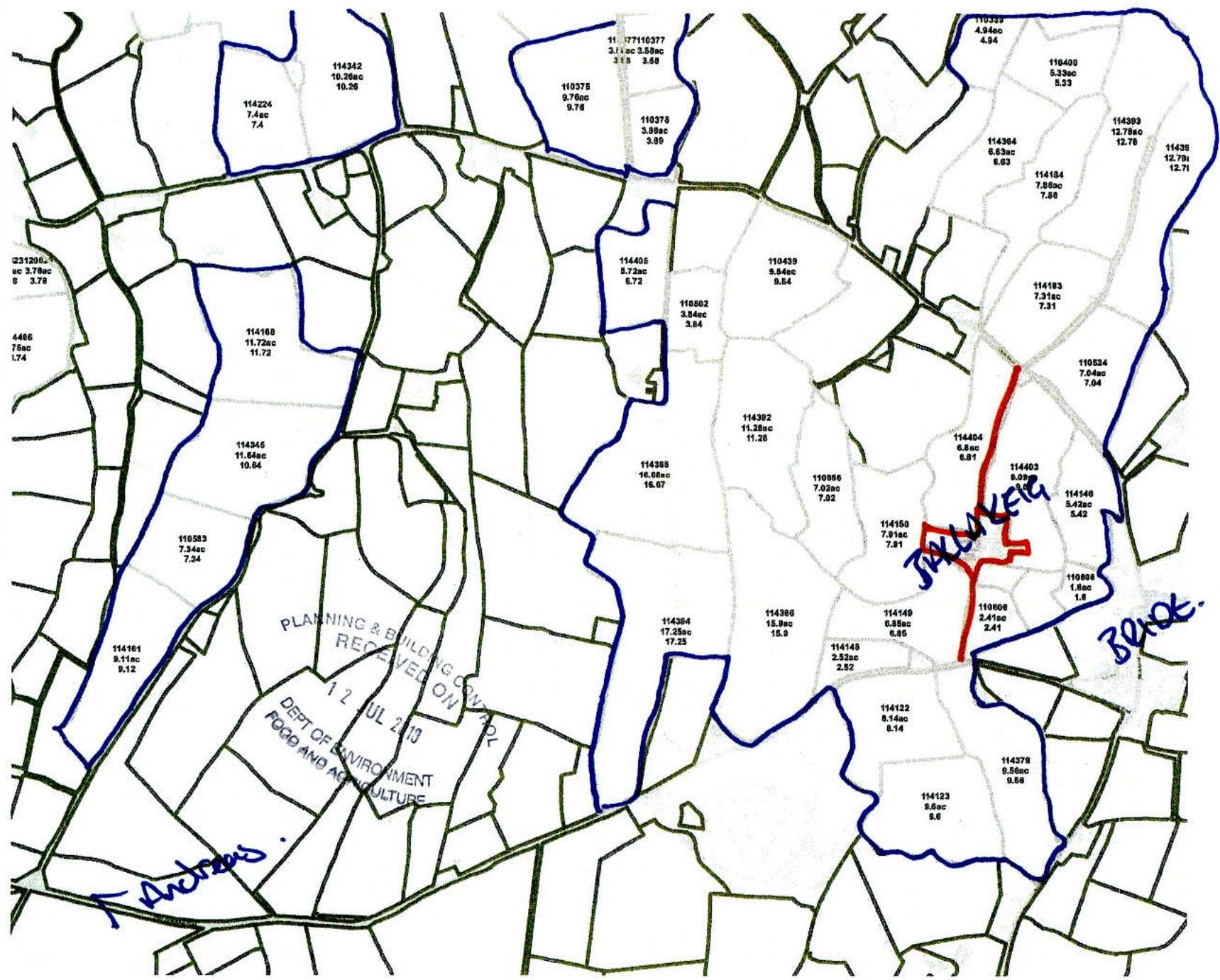 A scanned cadastral map displaying land parcels with numbers, boundaries, and handwritten administrative stamps.