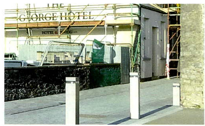 A street-level photograph showing the exterior facade of The George Hotel with scaffolding erected for renovation work.
