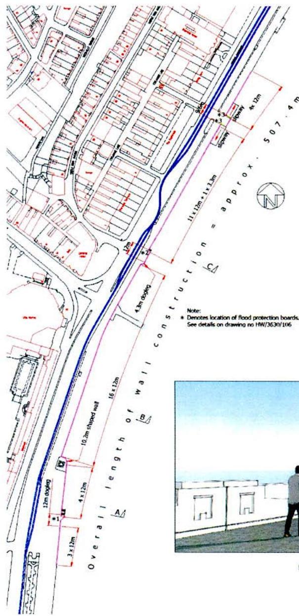 A technical site plan illustrating the proposed alignment and dimensions of a 507m long reinforced concrete sea wall along a coastline with adjacent caravan pitches.