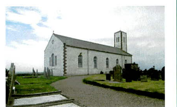 A photograph showing a white stone church with a tower and a graveyard in the foreground, set in a rural landscape.