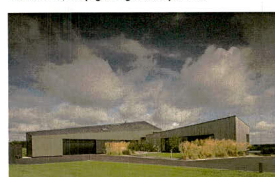 A digital rendering or photograph of a modern, single-story detached house with a flat roof and large windows set against a cloudy sky.