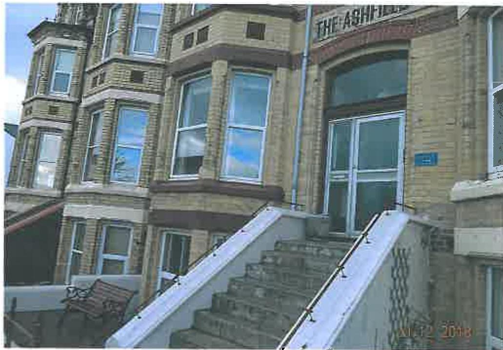 A photograph showing the front elevation of a large brick building named 'The Ashfield' with a prominent external staircase leading to the entrance.