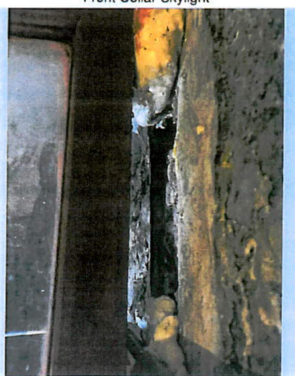 A close-up photograph labeled 'Front Cellar Skylight' showing a gap or joint between a stone wall and a frame, likely documenting existing conditions for the application.