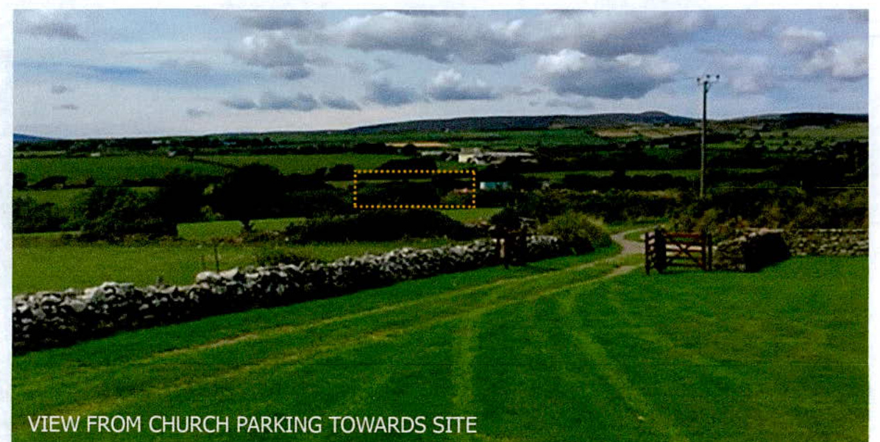A landscape photograph showing a rural view from a church parking area towards a designated site marked by a dotted yellow box.