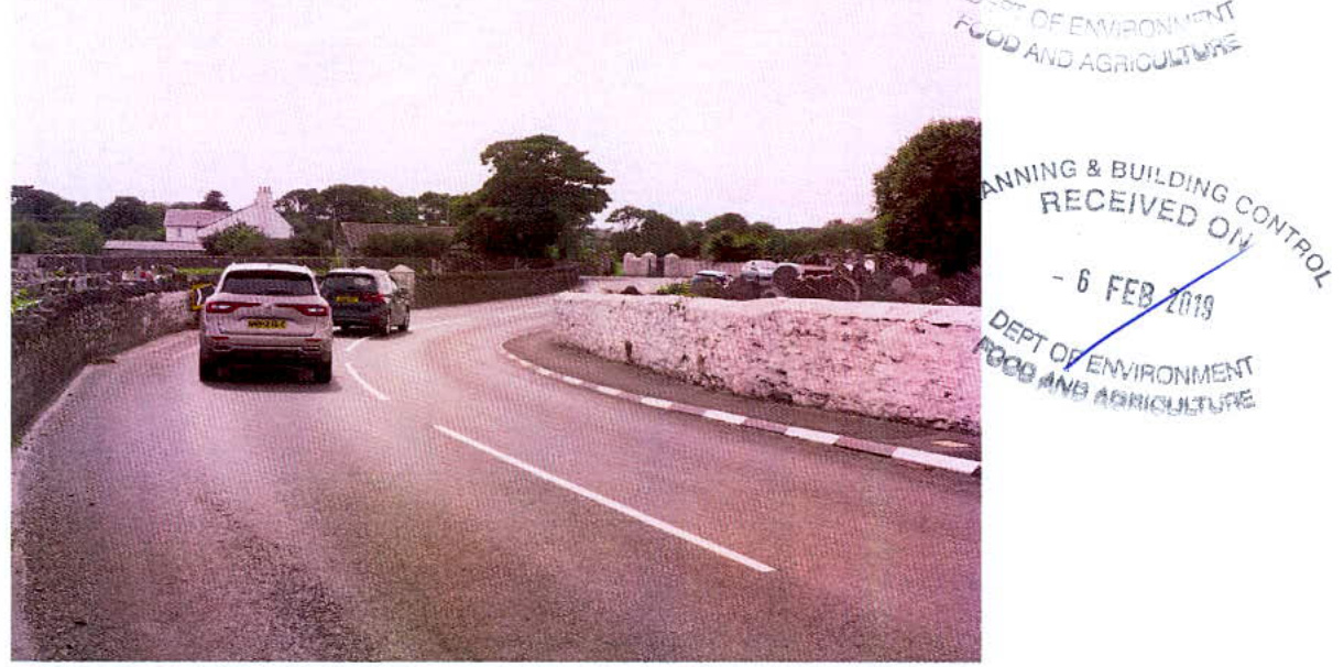 A photograph showing a road scene with vehicles and stone walls, likely depicting the existing site context for a cemetery extension, marked with a planning department receipt stamp.