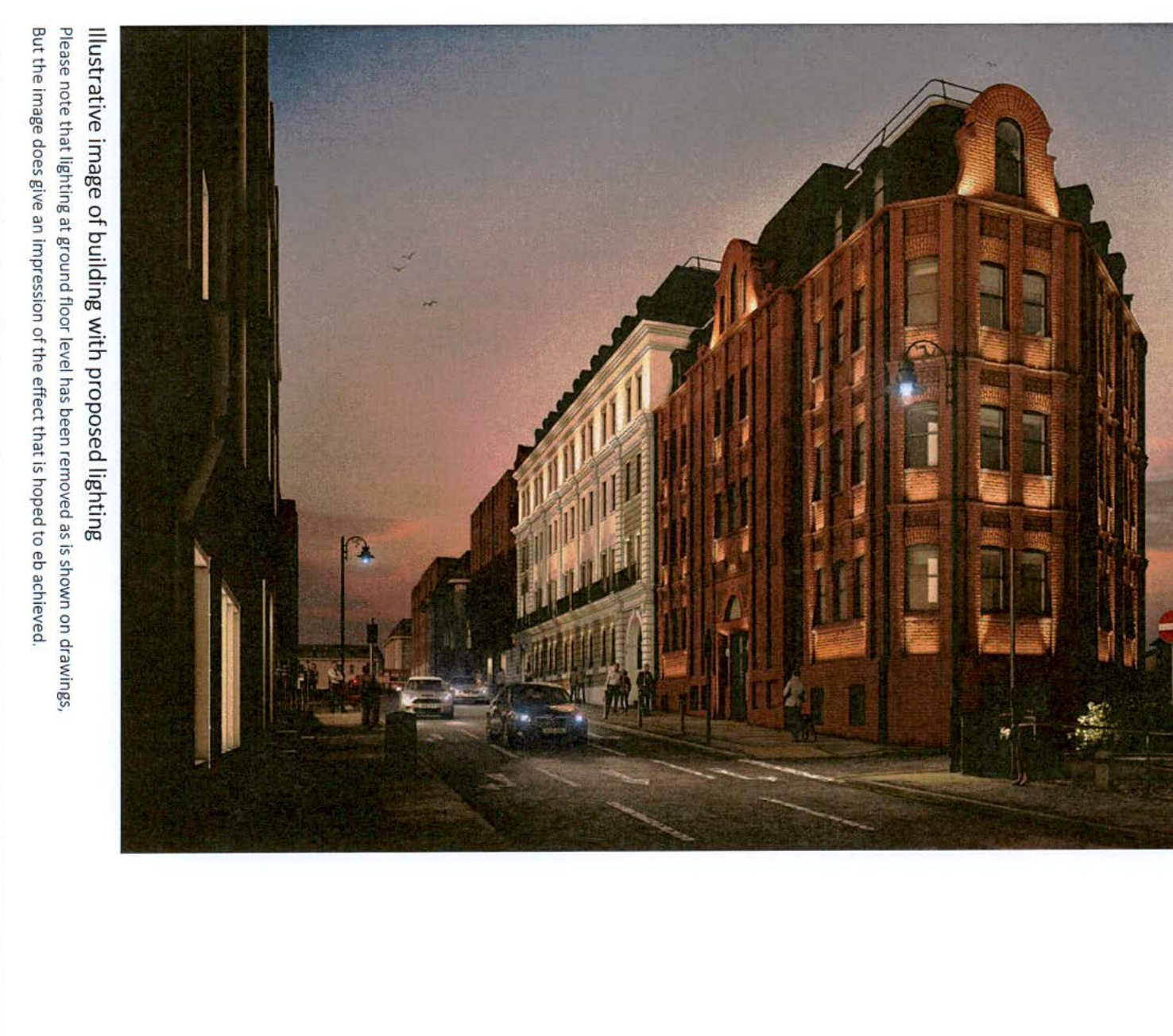 An illustrative night-time rendering of a brick commercial building on a street, demonstrating the effect of proposed external lighting.