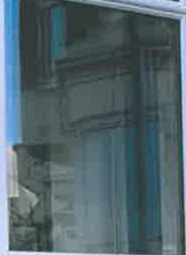 A close-up photograph of a window frame, likely showing the existing condition of the front elevation for a replacement application.