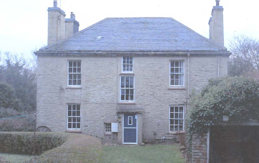 A photograph of a two-story stone house with a slate roof and chimneys, likely the Ballaradcliffe House mentioned in the application.