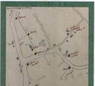 A hand-drawn sketch map showing a road network with labeled points and building outlines, likely indicating a site location.
