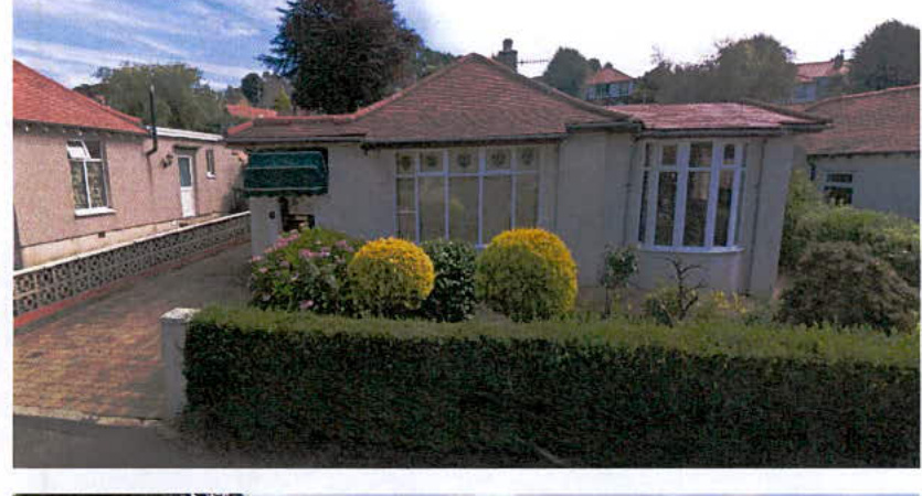 A photograph showing the front exterior of a single-story bungalow with a tiled roof and a paved driveway on the left.